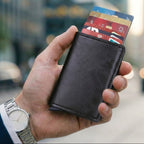 VETHO pop-up RFID blocking wallet in Midnight Black leather held in hand.